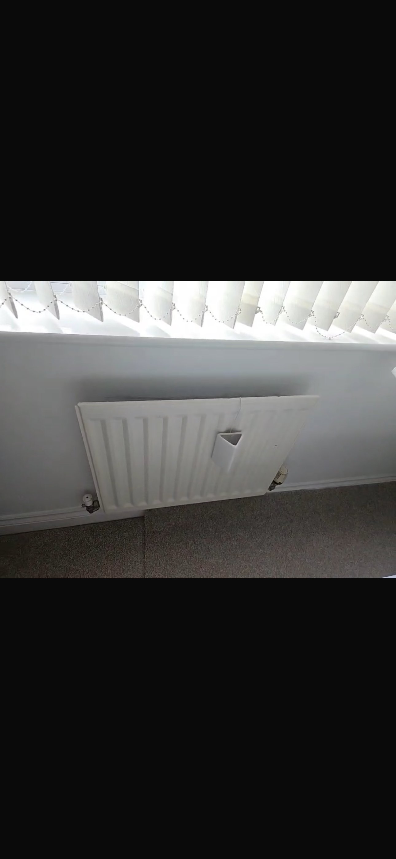 Heated towel radiator installation in a bathroom